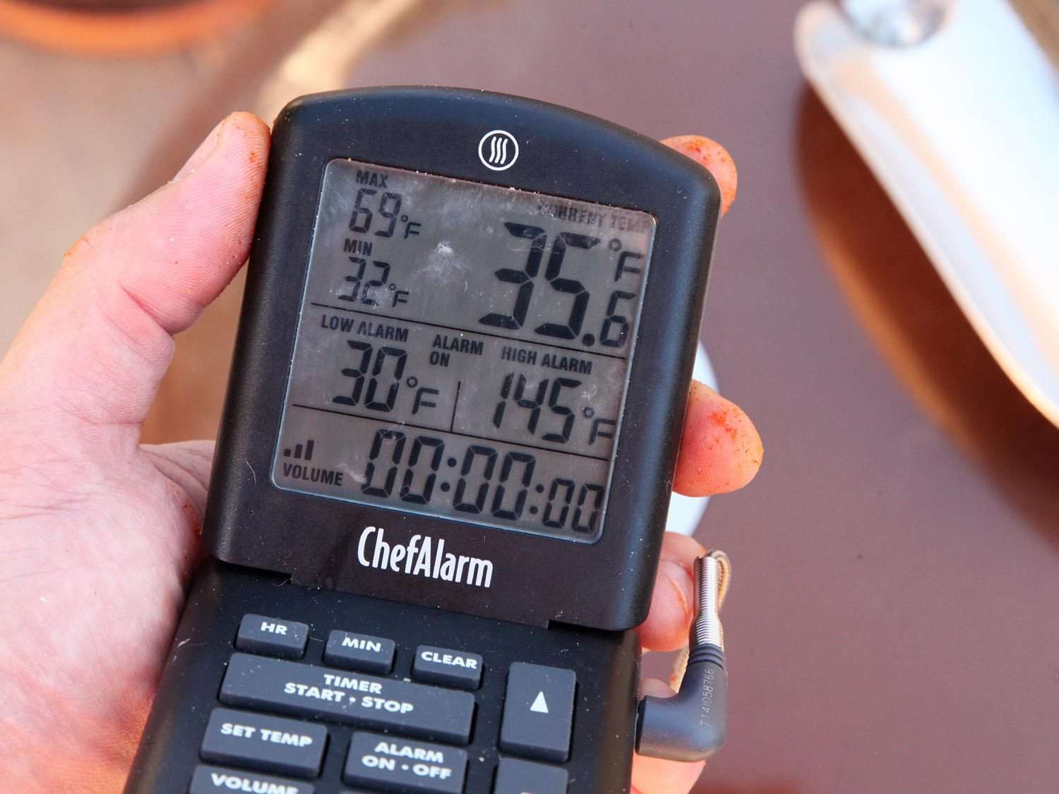 Checking temperatures on the display unit of a leave-in probe thermometer.