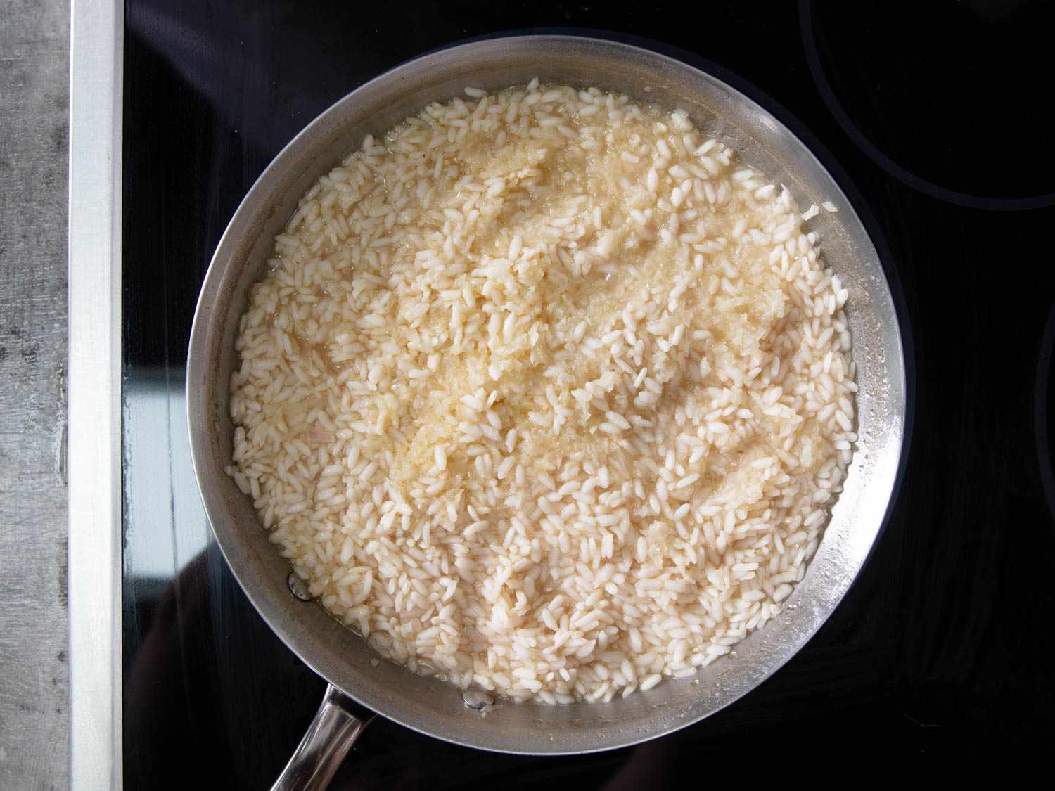 Risotto cooking in a wide shallow skillet