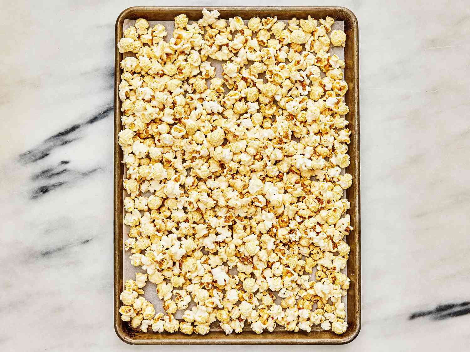 popped kettle corn cooling in a sheetpan 