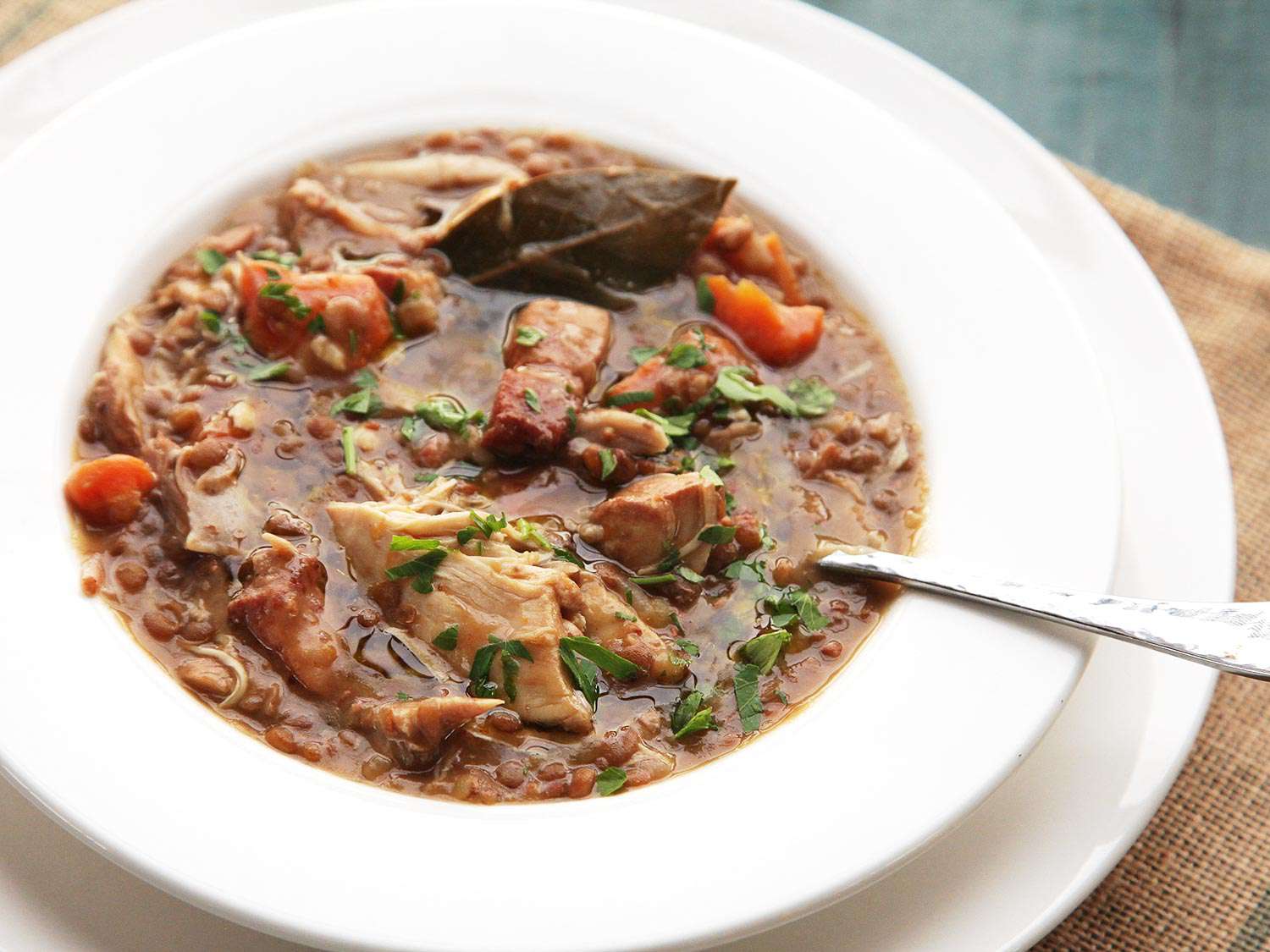 A bowl of Quick and Easy Pressure Cooker Chicken, Lentil, and Bacon Stew With Carrots. 
