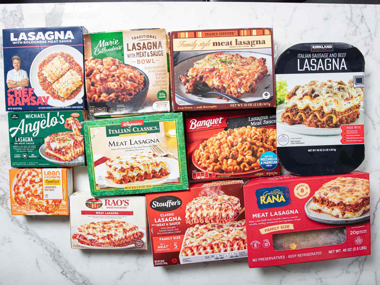 Various frozen lasagna packages arranged on a marble surface highlighting different brands and styles of lasagna