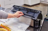 A person adjusts the FoodSaver V4400 2-in-1 Vacuum Sealer Machine bag