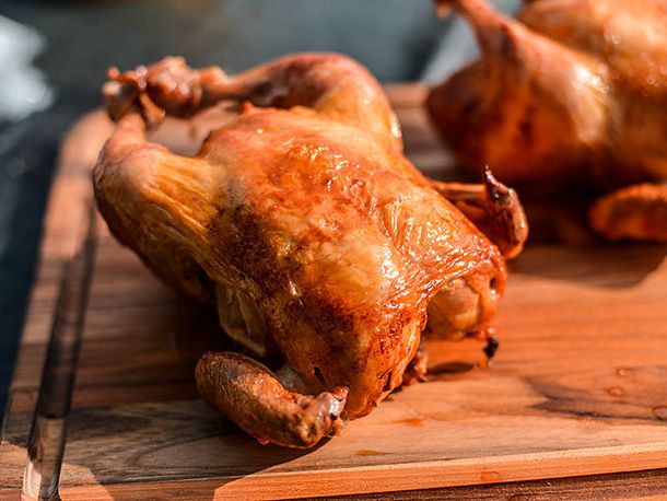 "Really excellent" rotisserie chicken, transferred to rest on a cutting board.