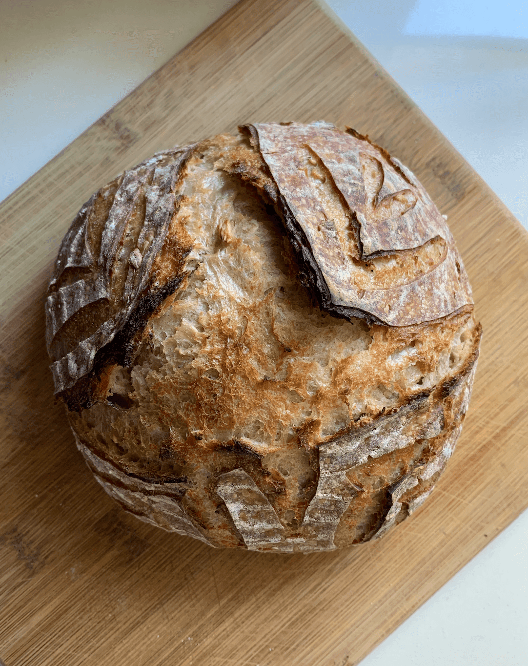 overhead view of loaf of bread on cutting board