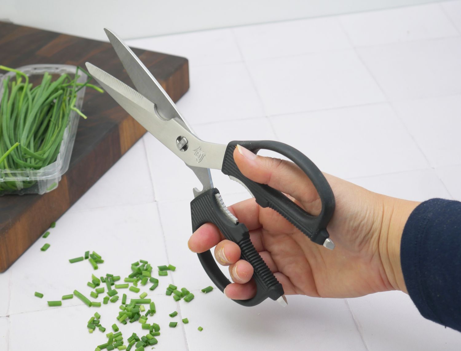 a person holding the shun shears