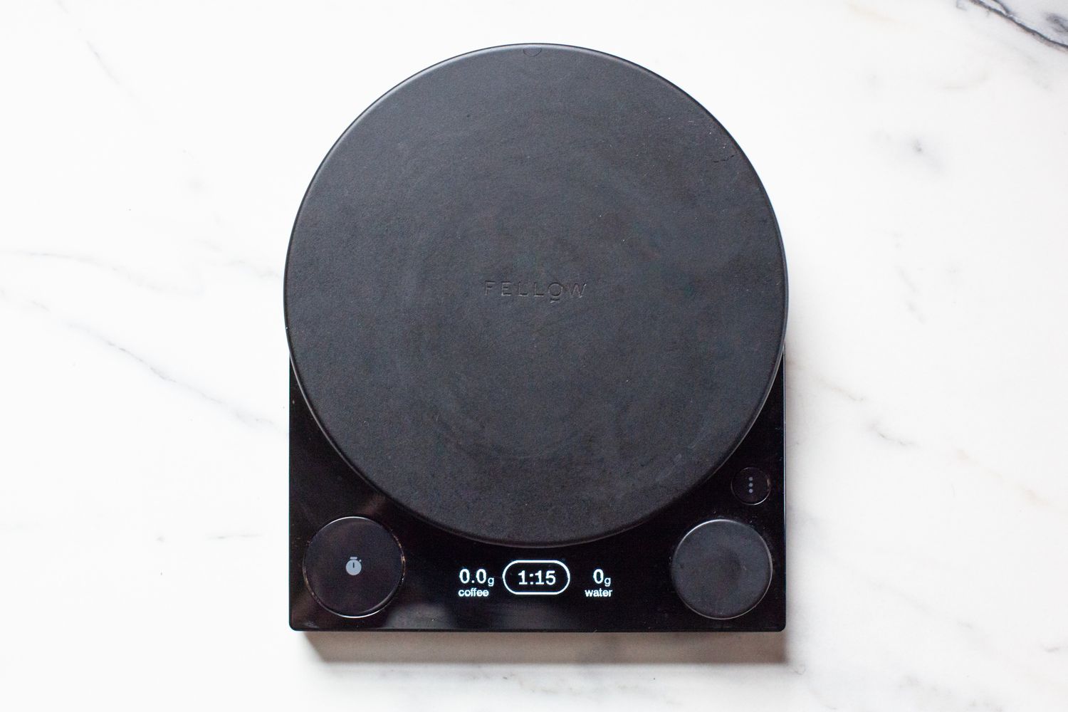 The Fellow Tally Pro Coffee Scale on a marble countertop.