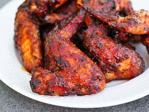 A plate of grilled sweet and spicy chicken wings. 