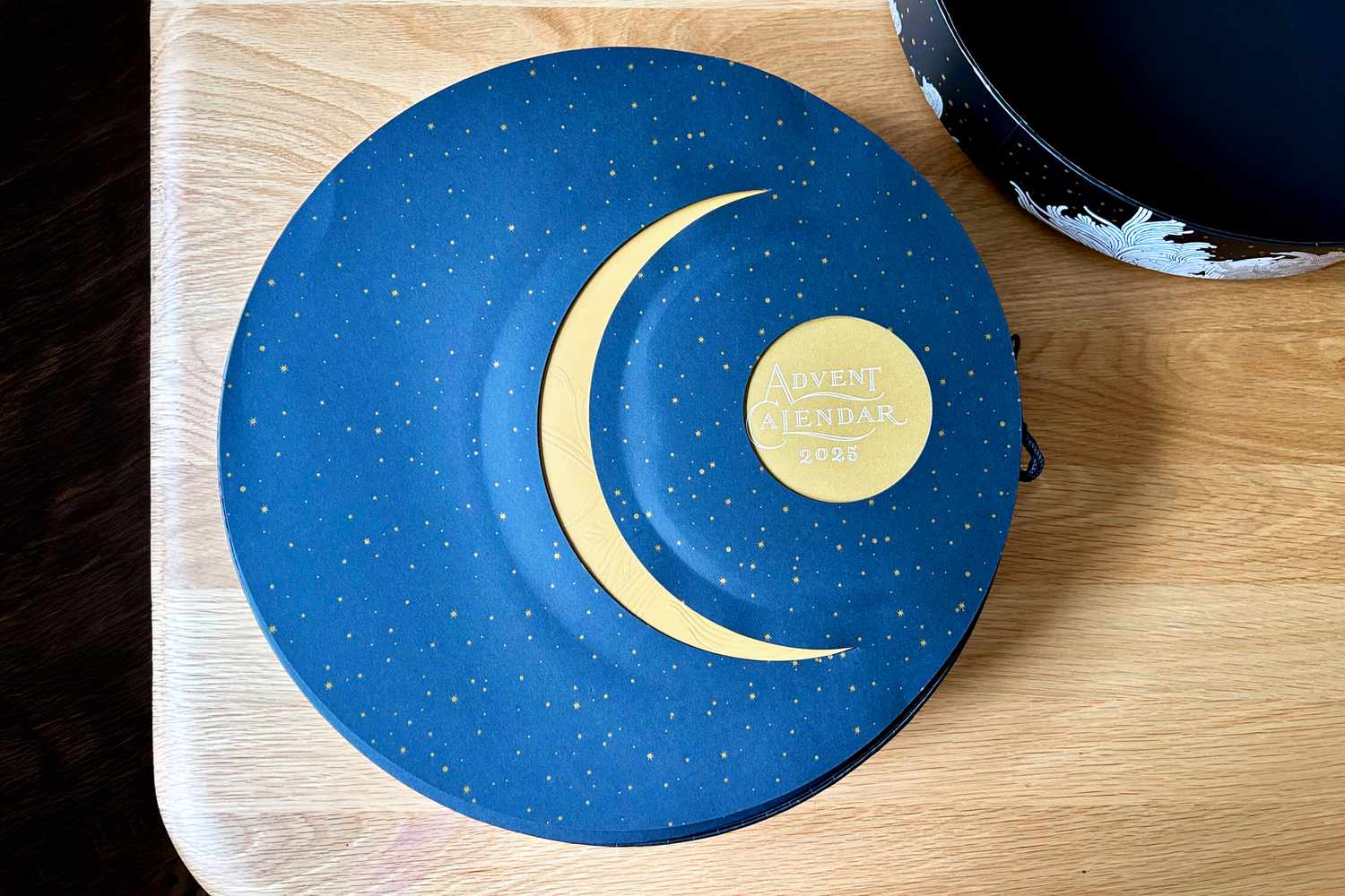 The blue and moon-illustrated bottom of the Dandelion Chocolate Advent calendar