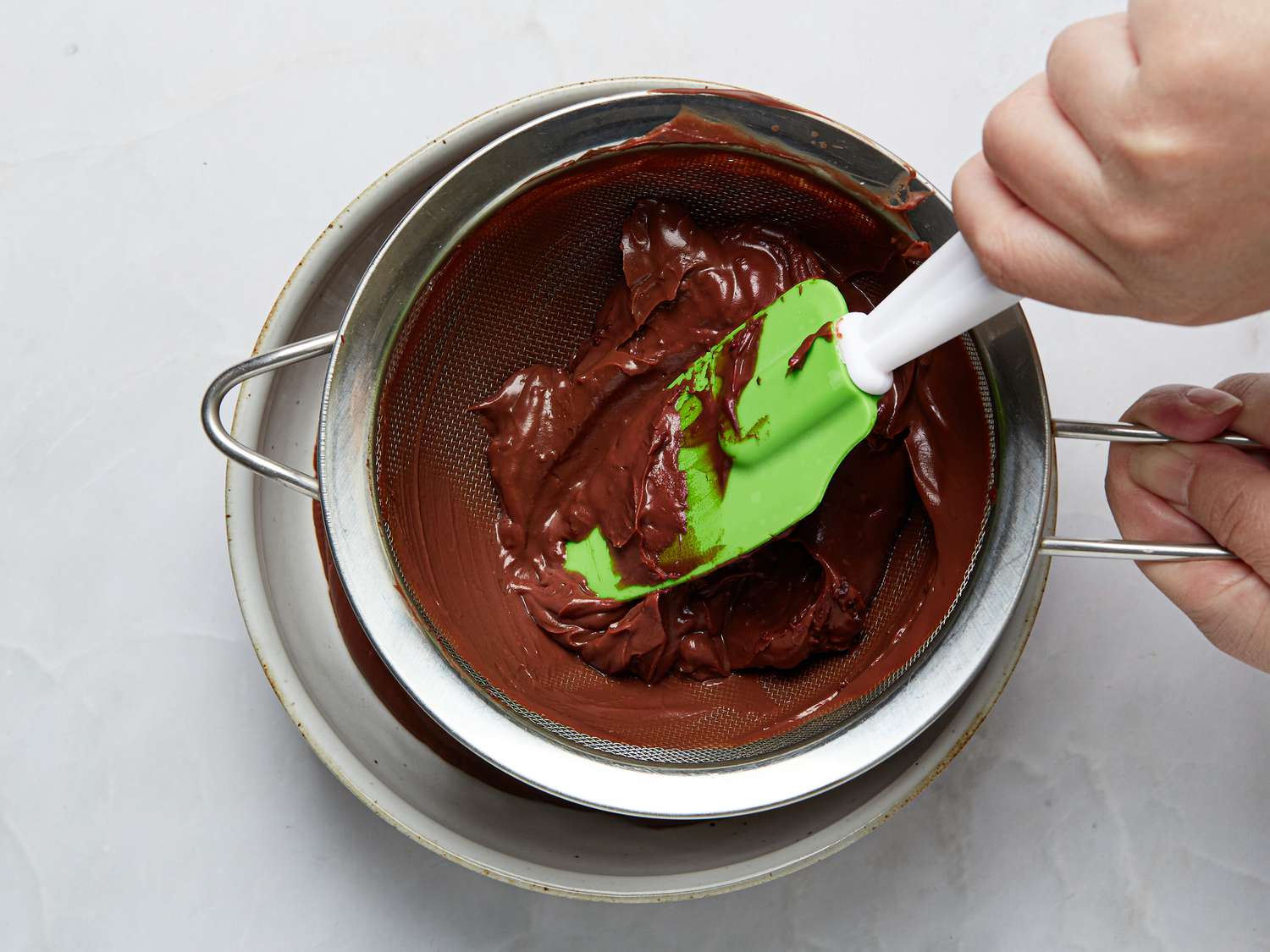 straining chocolate with into medium bowl with a fine mesh sieve 