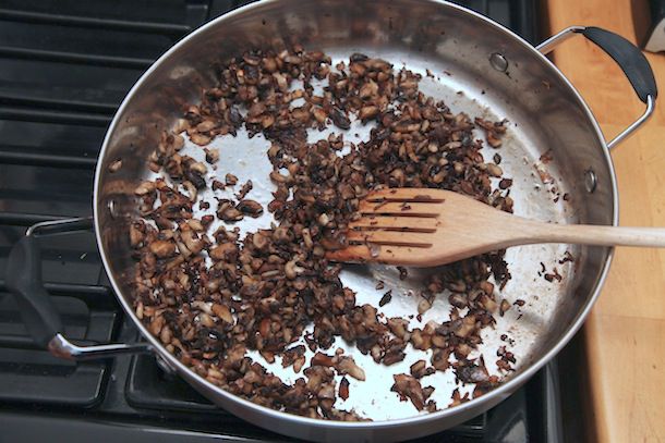 The blend of chopped mushrooms has been cooked down and browned in the wide saucepan.