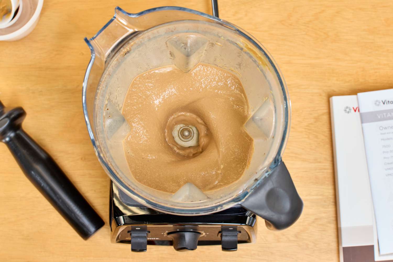 An overhead view of the Vitamix 7500 blending items without a lid
