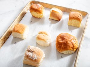 Six dinner rolls on a baking sheet lined with parchment paper numbered 1 to 6