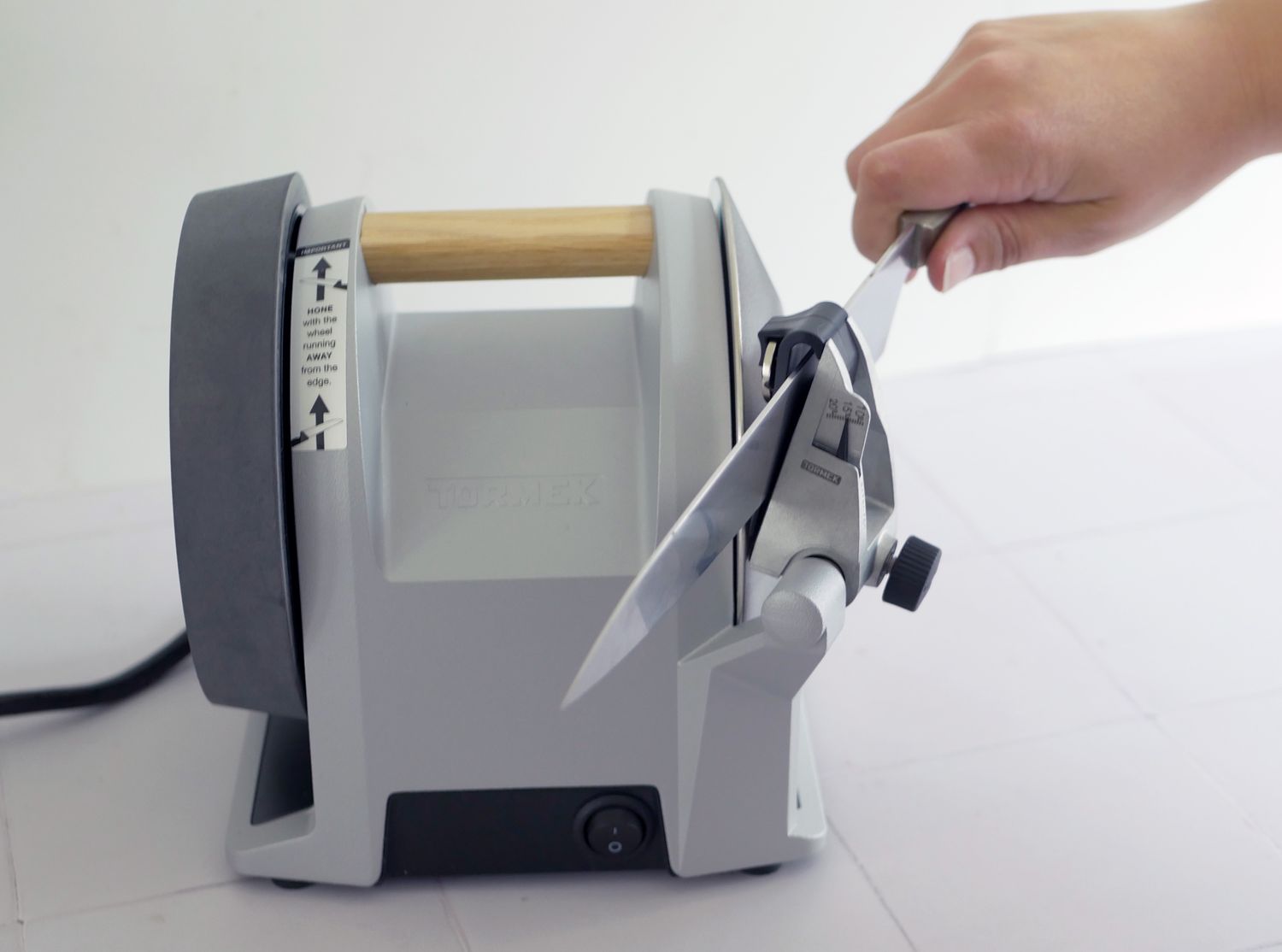 a person sharpening a knife on the tormek