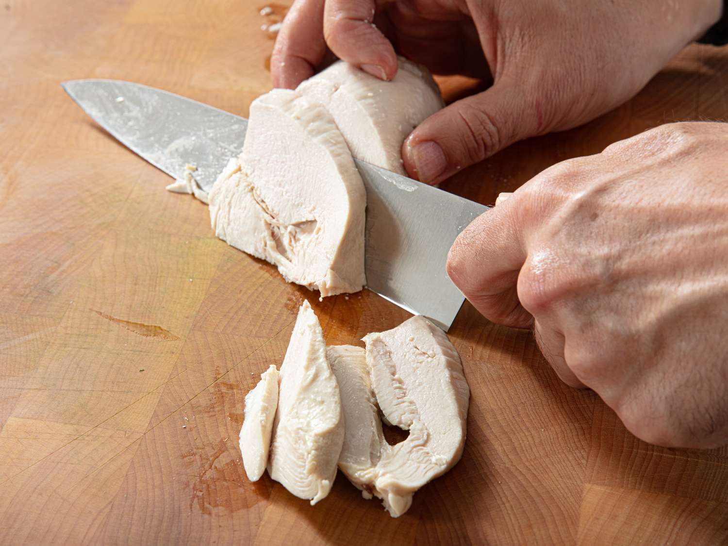 Overhead view of slicing chicken
