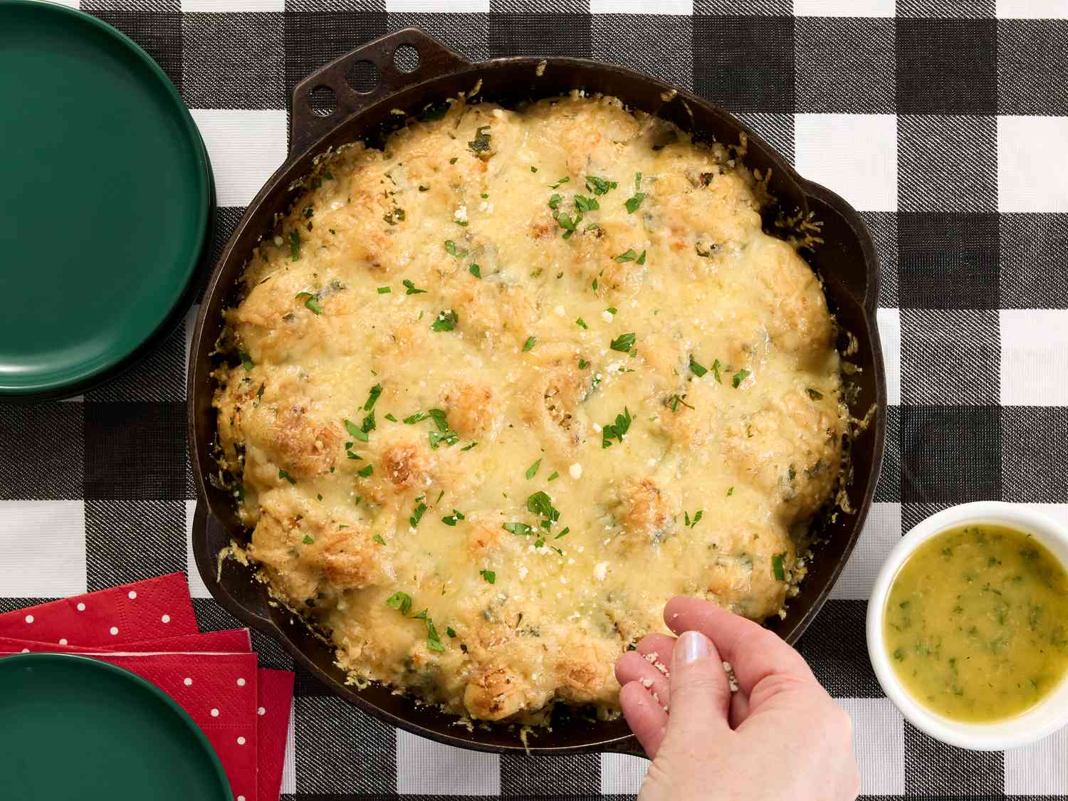garnishing garlic knots with Parmeson cheese 