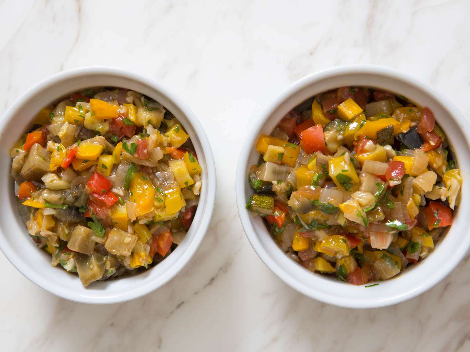 Two ramekins with different batches of ratatouille. The one-pot version looks a little less defined than the one made with individually-cooked vegetables.