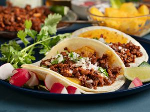 Plated tacos al pastor from the side
