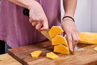A person cuts squash using the Wüsthof Classic 8-Inch Chef's Knife