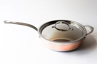 A saucepan with a lid and a long handle displayed on a white background
