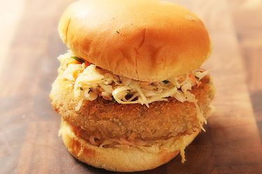 Closeup of a Crispy Fried Chickpea Cake and Slaw Sandwich.