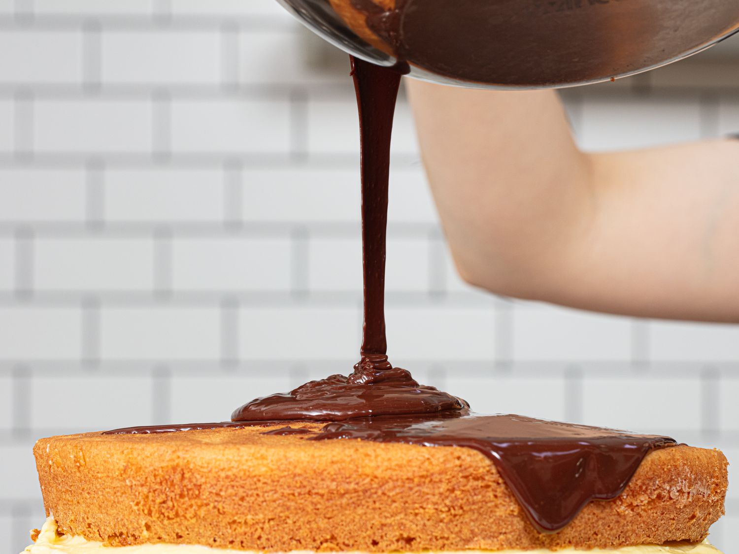 Side view of pouring chocolate