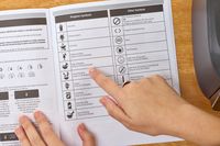 A hand pointing to a line in the Vitamix Ascent X5 Blender handbook