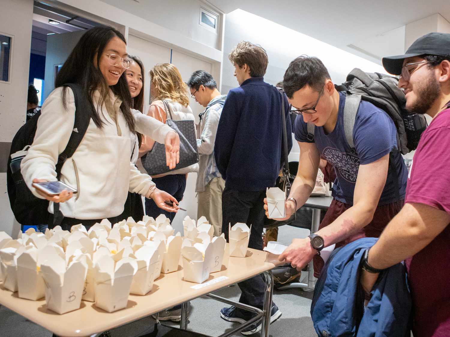 From left to right: Vivian Nha Nguyen (a member of the Harvard Fart Squad) and Nancy Lin, hand out bean puree samples for students Etai Clyde and Juan Valdez to eat
