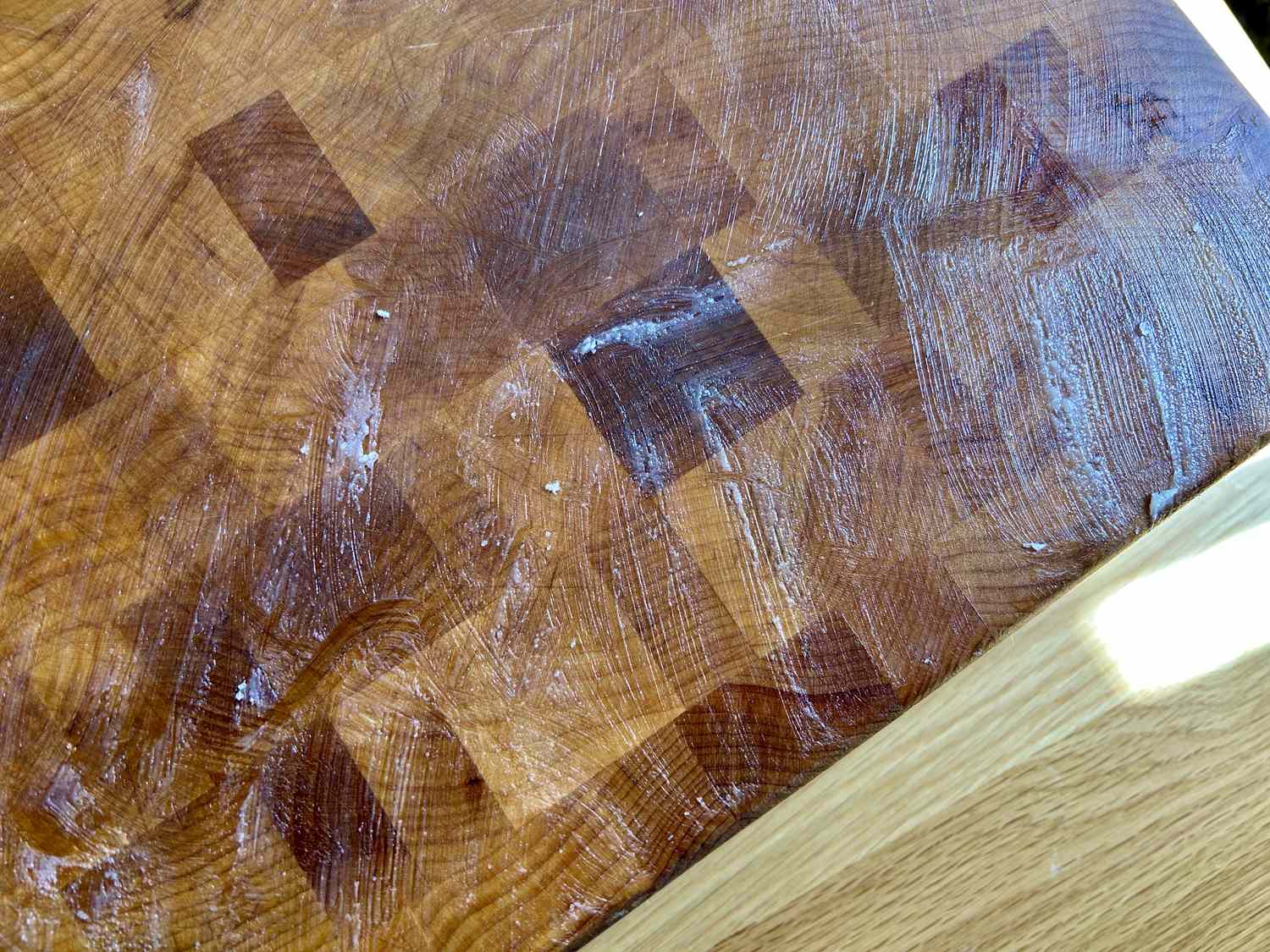 Boos Block Board Cream slathered on a wooden cutting board