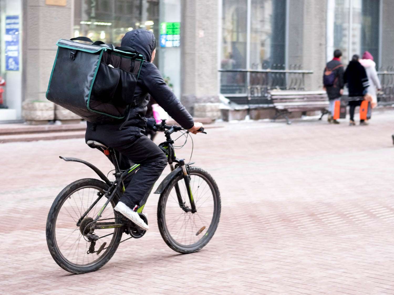 Food delivery person riding a bicycle