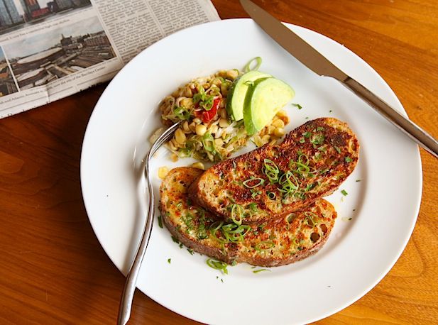 Savory cheese-crusted French toast, served on a white plate.