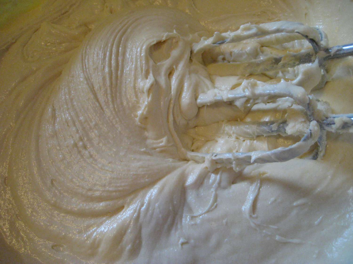 Sugar, eggs, and vanilla are mixed in to make a smooth batter. 