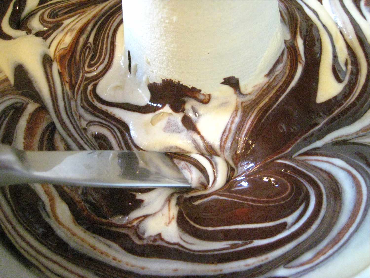 Melted chocolate is swirled in with a butter knife.