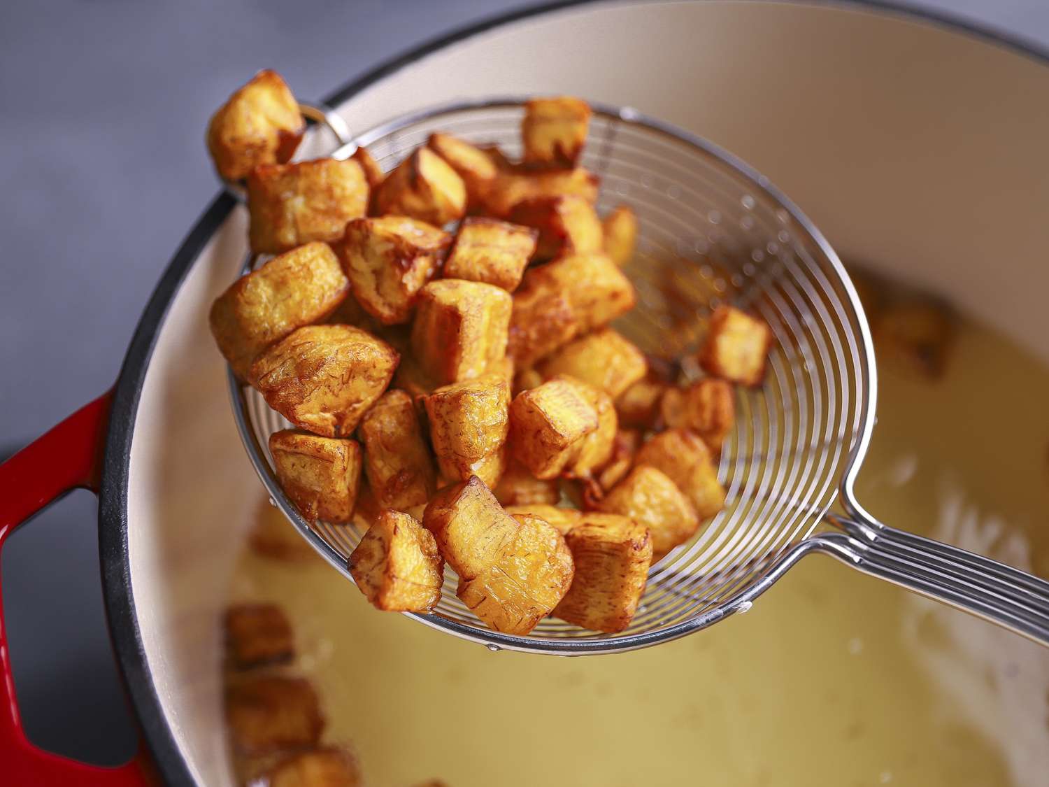 Golden fried plantains in a spider