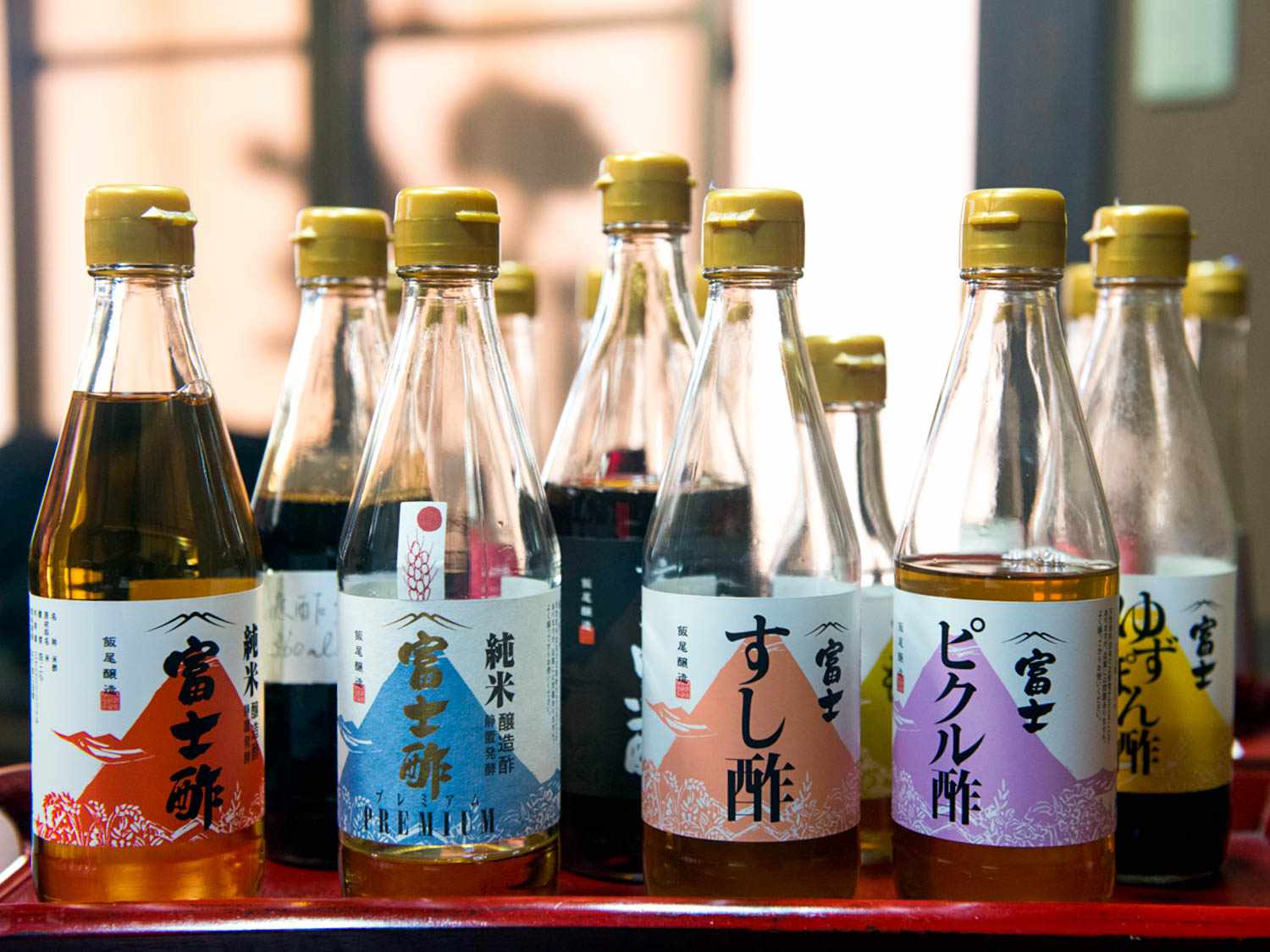 An entire tray of Japanese rice vinegar bottles.