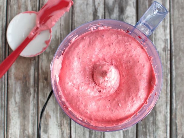Egg whites and frozen berries in the bowl of a food processor, whipped into a creamy mixture. 
