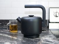 fellow clyde electric tea kettle with tea cup behind it