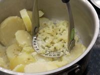 closeup of the prepara potato masher mashing potatoes