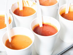 Cups of tomato soup with spoons presented for a taste test