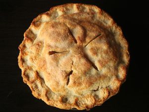 An overhead view of a double-crust pie with crimped edges.