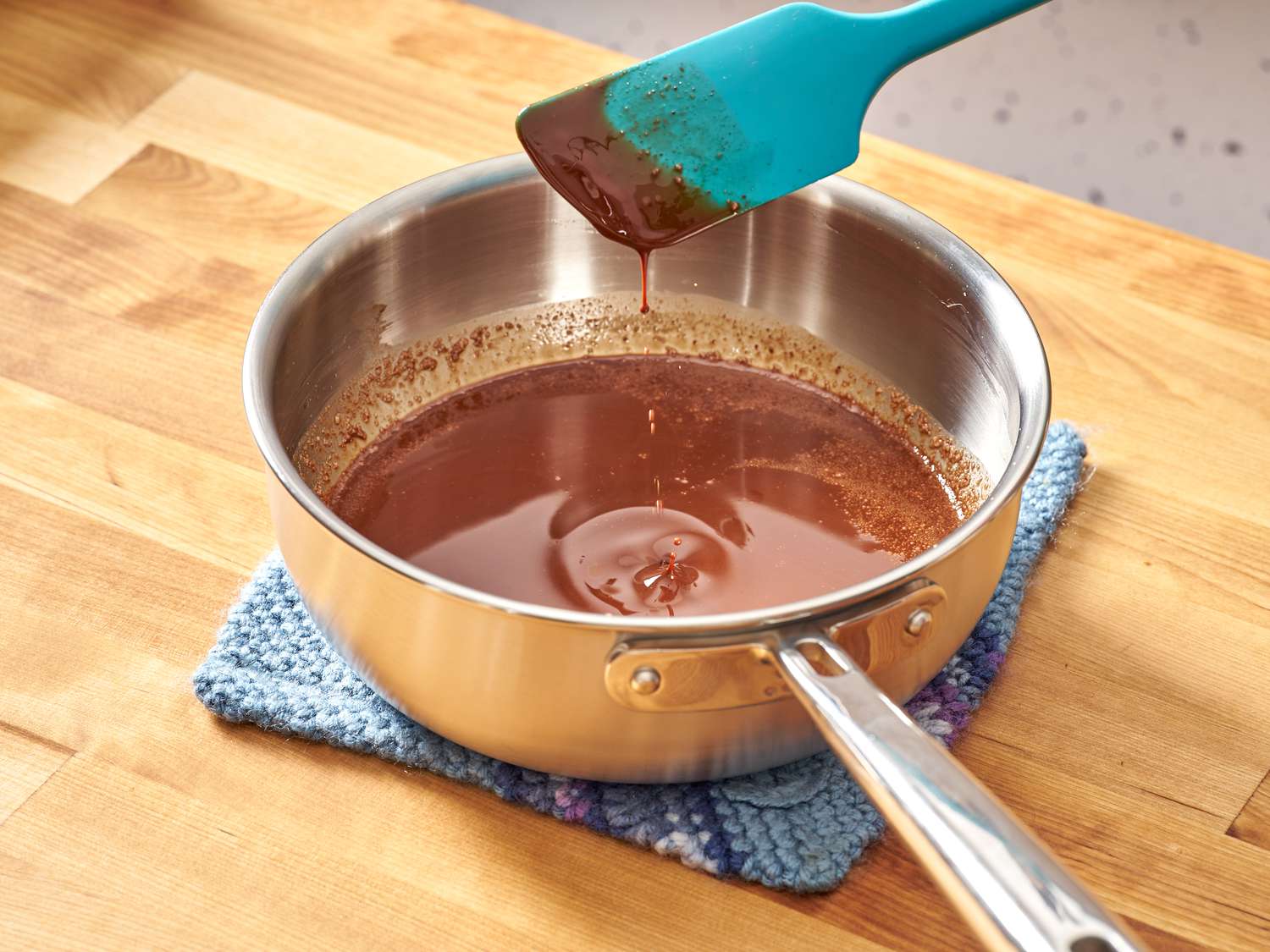 A thin butter-chocolate mixture in a saucier.