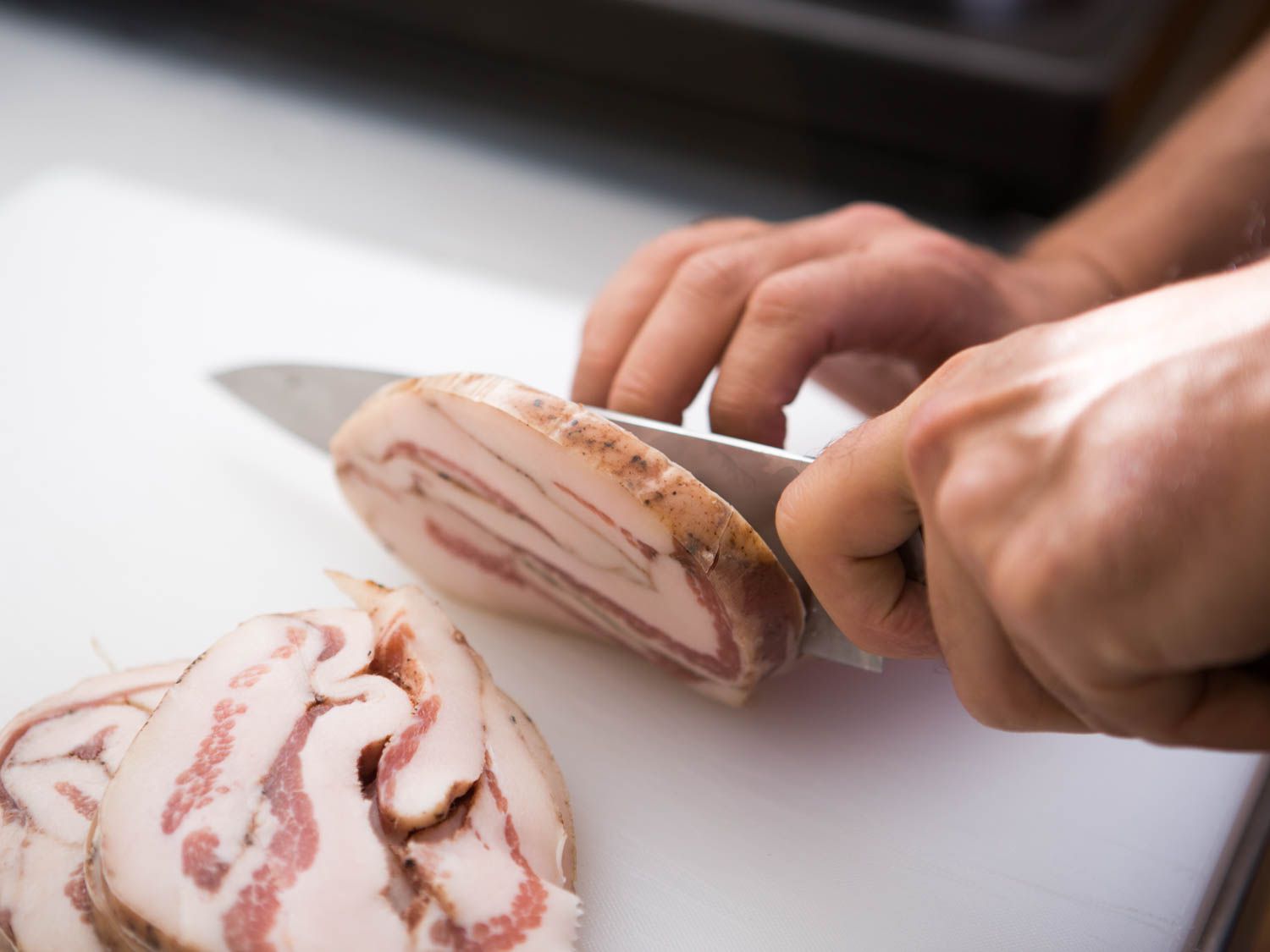 Slicing guanciale for pasta carbonara.