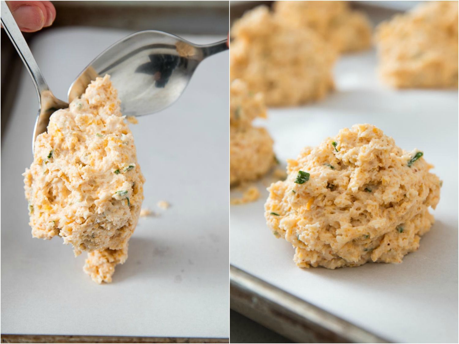 Cheddar bay biscuit dough is spooned onto a parchment-lined baking sheet.