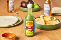 El Yucateco Salsa Picante Verde De Chile Habañero sitting on table