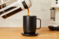 French press coffee being poured into an Ember Mug 2 on a charging pad
