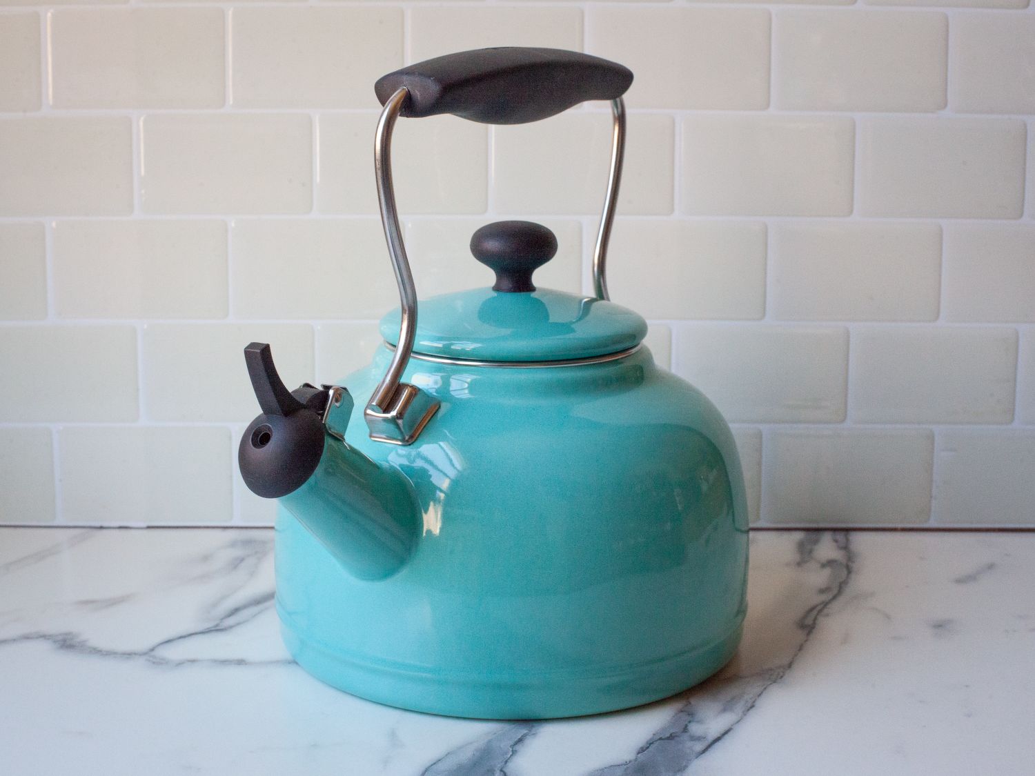 a blue kettle on a marble surface