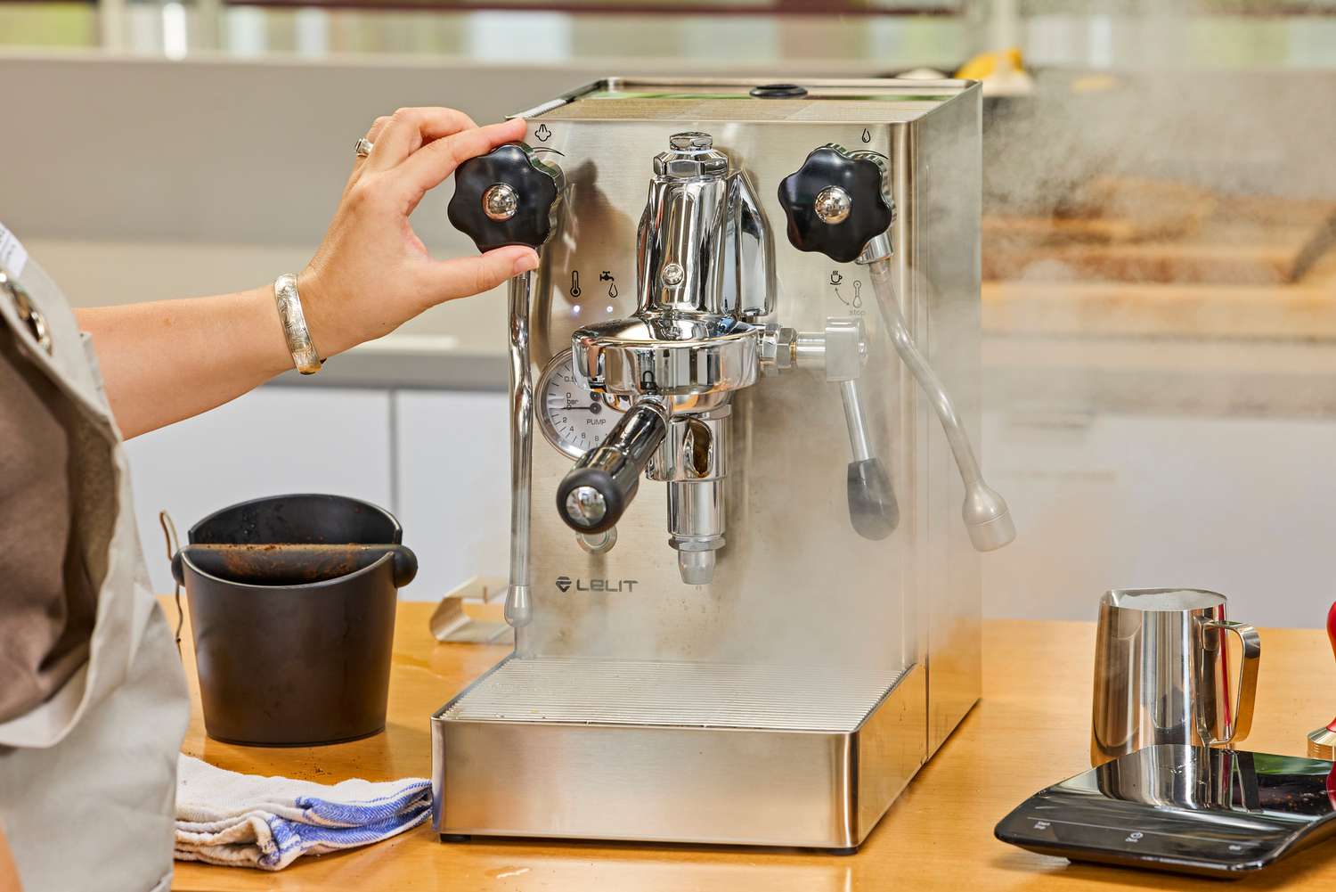 A hand turning a nob on the Lelit MaraX Espresso Machine PL62X-120