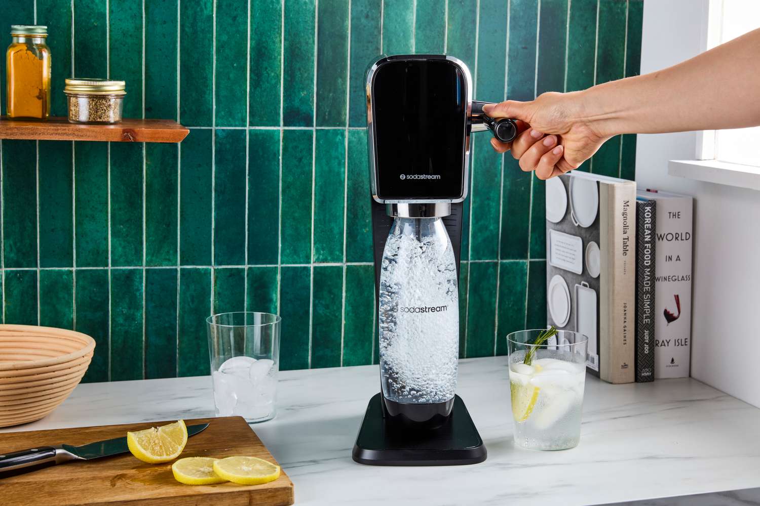 A person carbonating water with the SodaStream Art.