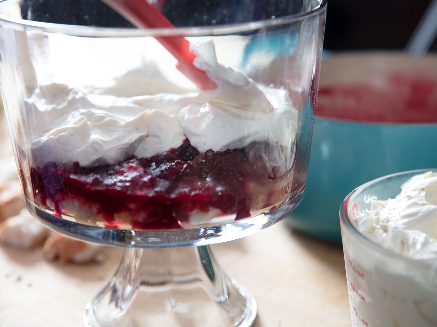 A layer of whipped mascarpone is spread over the jam layer with a spatula.