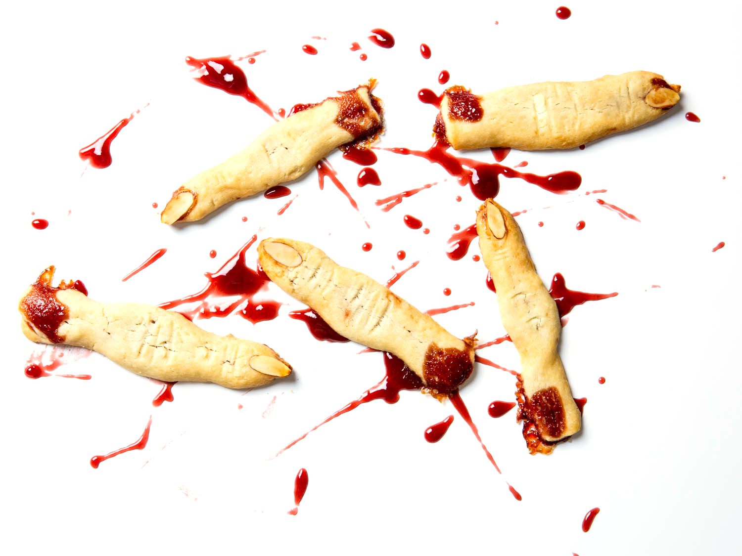 Witch finger cookies with almond fingernails and raspberry jam standing in for blood.