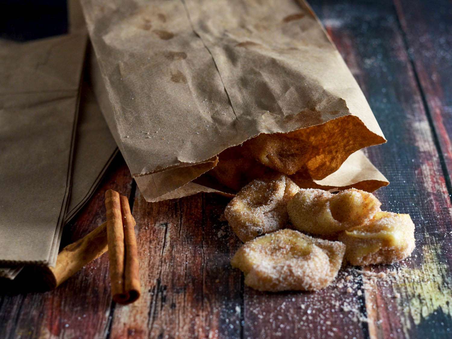 Coated wontons are removed from the paper bag.